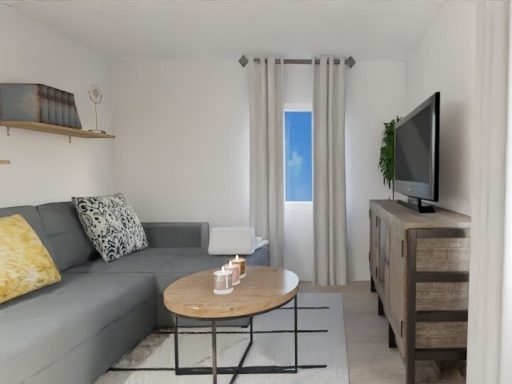 Sala de estar luminosa con sofá gris, mesa de café y TV en una pared.